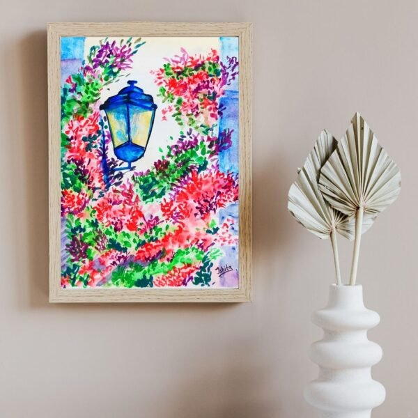 Framed watercolor floral wall art featuring a glowing blue street lantern with red, purple, and green blossoms